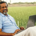 Sridhar Vembu, founder of Zoho, sitting in front of the rural Tenkasi office, symbolizing decentralized talent and rural development.
